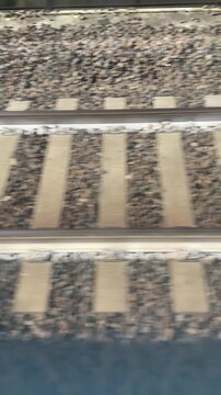 Railway Tracks: A close-up of parallel railway tracks stretching into the distance, a symbol of journey, transit, and infrastructure.  Emphasizing the raw power and precision of transport systems