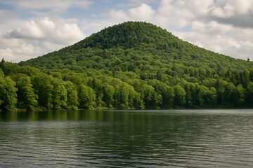 A Serene Lake Surrounded by Lush Green Forests Under a Partly Cloudy Sky