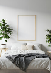 A blank vertical poster frame mockup hangs on a white wall above a cozy bed in a modern, minimalist bedroom.