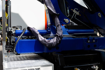 Hydraulic system on a construction crane. The image highlights the blue hydraulic cylinder,...