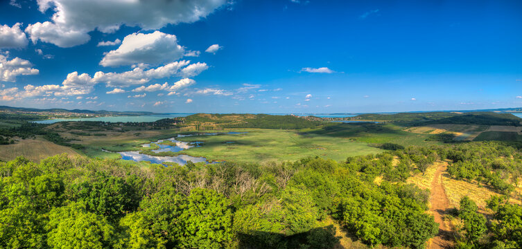 Panoramafoto vom Aussichtsturm "Őrtorony-kil&aacute;t&oacute;" &uuml;der die Halbinsel Tihany im Plattensee in Ungarn mit Sumpfland, Feldern und W&auml;ldern bei sch&ouml;nem, sonnigen Sommerwetter