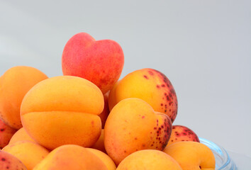 Several apricots on a gray background with copy space, selective focus