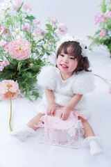A Birthday Bliss: a sweet girl joyfully celebrates, surrounded by an array of delicate flowers....
