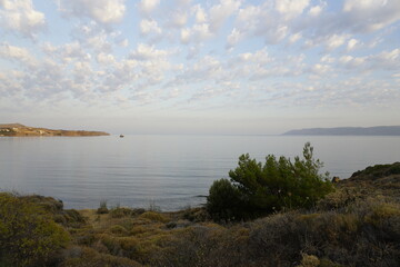 Early morning on the Aegean Sea in July. Bright colorful sunrise and clouds. Light and shadows	