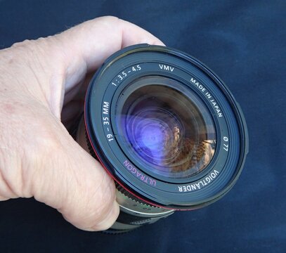 Photographer holding Voigtlander Ultron 19-35mm lens