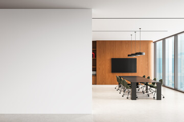 Blank white wall in modern office interior with meeting room and large windows, perfect for poster...