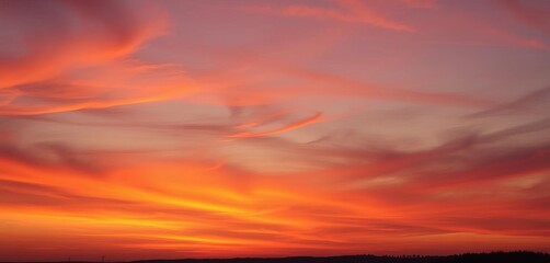 Fiery orange and purple hues melt into a tranquil twilight sky,  vibrant,  pink