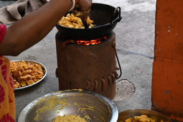 Onion pakora frying in iron pen. This is a popular street food in Indian subcontinent. Onion which...