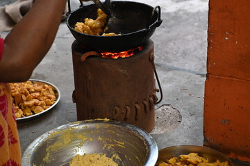 Onion pakora frying in iron pen. This is a popular street food in Indian subcontinent. Onion which...