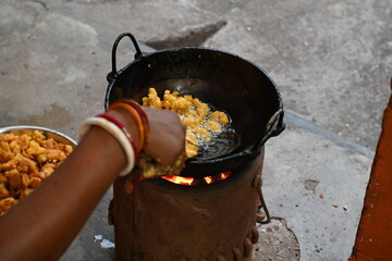 Onion pakora frying in iron pen. This is a popular street food in Indian subcontinent. Onion which...