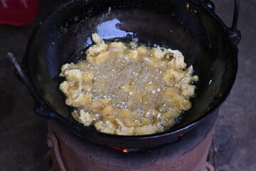 Onion pakora frying in iron pen. This is a popular street food in Indian subcontinent. Onion which...