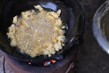 Onion pakora frying in iron pen. This is a popular street food in Indian subcontinent. Onion which...