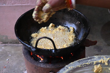 Onion pakora frying in iron pen. This is a popular street food in Indian subcontinent. Onion which...