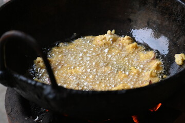 Onion pakora frying in iron pen. This is a popular street food in Indian subcontinent. Onion which...