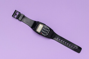 Vintage Calculator Watch on Purple Background: Retro Style and Technology Nostalgia