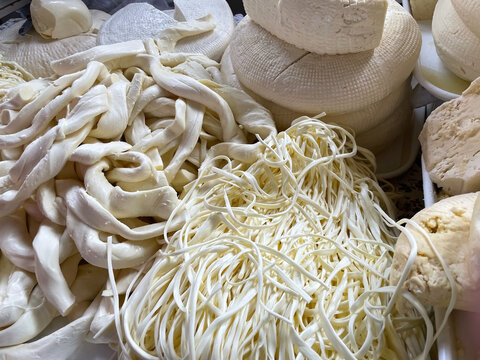 Assortment Of Fresh Traditional Caucasian Cheese, Including String Cheese (Chechil) And Suluguni, At A Farmers Market. Dairy Product Background.