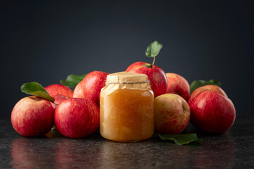 Apple jam and red fresh apples.