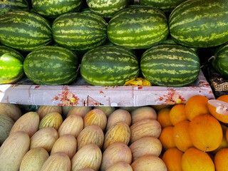 Fresh Fruit Stall With Neat Rows Of Green Watermelons And Different Melons (Cantaloupe, Honeydew)....