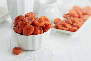 Organic dried apricots on a white table.