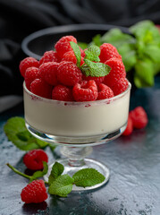 Mascarpone cream with fresh raspberries in a clear bowl.