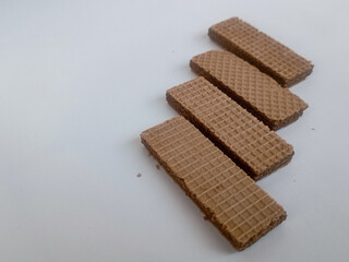 scrumptious piles of crunchy chocolate wafers isolated on white Background 