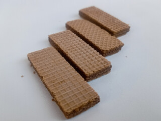 scrumptious piles of crunchy chocolate wafers isolated on white Background 