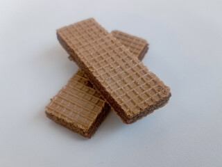 scrumptious piles of crunchy chocolate wafers isolated on white Background 