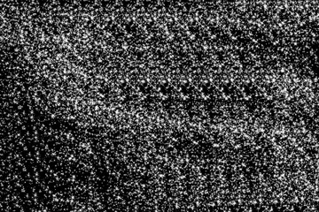 Abstract monochrome texture of densely packed small seeds or grains creating a grainy and speckled background pattern