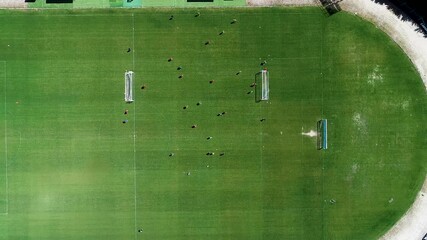 A static overhead shot of a bustling soccer field full of activity community engagement concept