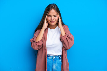 Young caucasian woman isolated on blue background with headache
