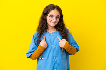 Little nurse girl isolated on yellow background with surprise facial expression