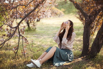 Happy Woman Enjoying Sunshine Under Blossoming Tree in Spring Garden © Buyanskyy Production
