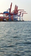 Industrial cargo container ship loading and discharging in logistics terminal port. Logistics and...