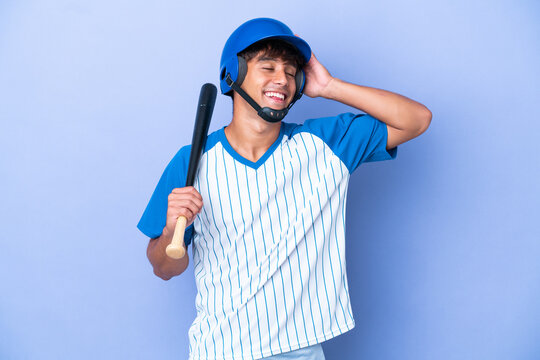 Baseball caucasian man player with helmet and bat isolated on blue background smiling a lot - Powered by Adobe