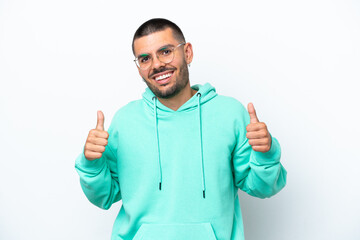 Young caucasian man isolated on white background giving a thumbs up gesture