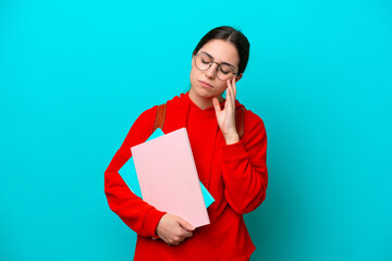 Young student caucasian woman isolated on blue background with headache