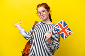 Young hispanic woman holding an United Kingdom flag isolated on yellow background extending hands...