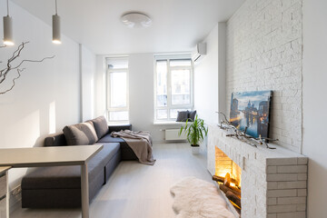 studio in minimalist style, fireplace, sofa