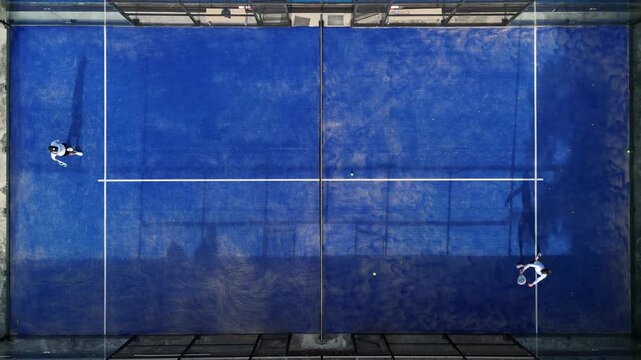 Aerial view of practice people at the blue paddle tennis courts