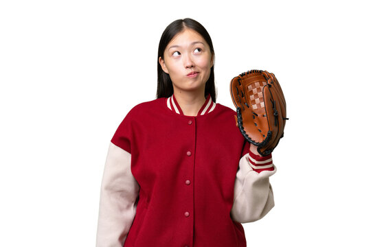 Young asian woman with baseball glove over isolated background and looking up
