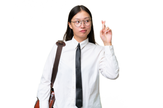 Young Asian business woman over isolated background with fingers crossing and wishing the best