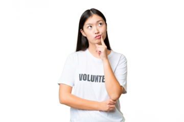 Young volunteer woman over isolated chroma key background having doubts while looking up