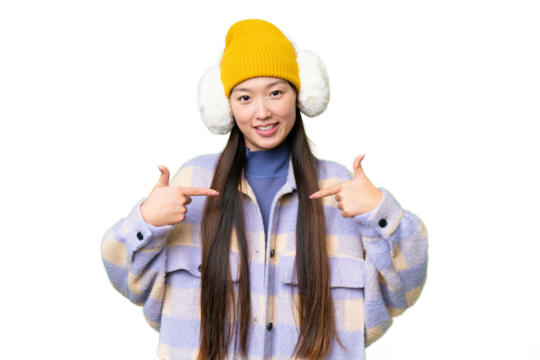 Young Asian woman wearing winter muffs over isolated chroma key background proud and self-satisfied