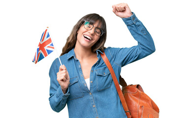 Young caucasian woman holding an United Kingdom flag over isolated background celebrating a victory