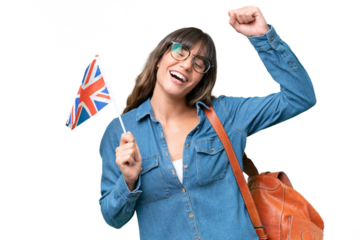 Young caucasian woman holding an United Kingdom flag over isolated background celebrating a victory