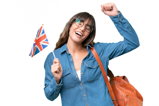 Young caucasian woman holding an United Kingdom flag over isolated background celebrating a victory