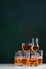 Strong alcoholic drinks set. Spirits, liqueurs, distillates etc. in glasses. Drink background banner. Hard alcohol in assortment