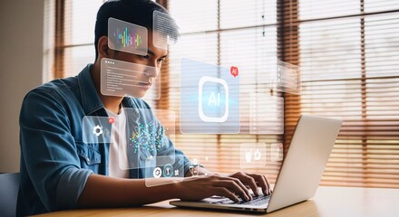Man working on laptop with AR: A man focused intently, as holographic interfaces overlay his perspective while using a laptop, highlighting the fusion of technology.
