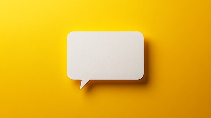 Blank white speech bubble on vibrant yellow background for message or creative design