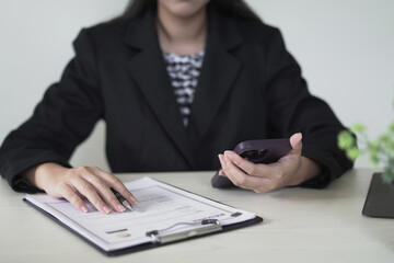 Young asian businesswoman employer holds resume and talks with candidate for recruitment interview...